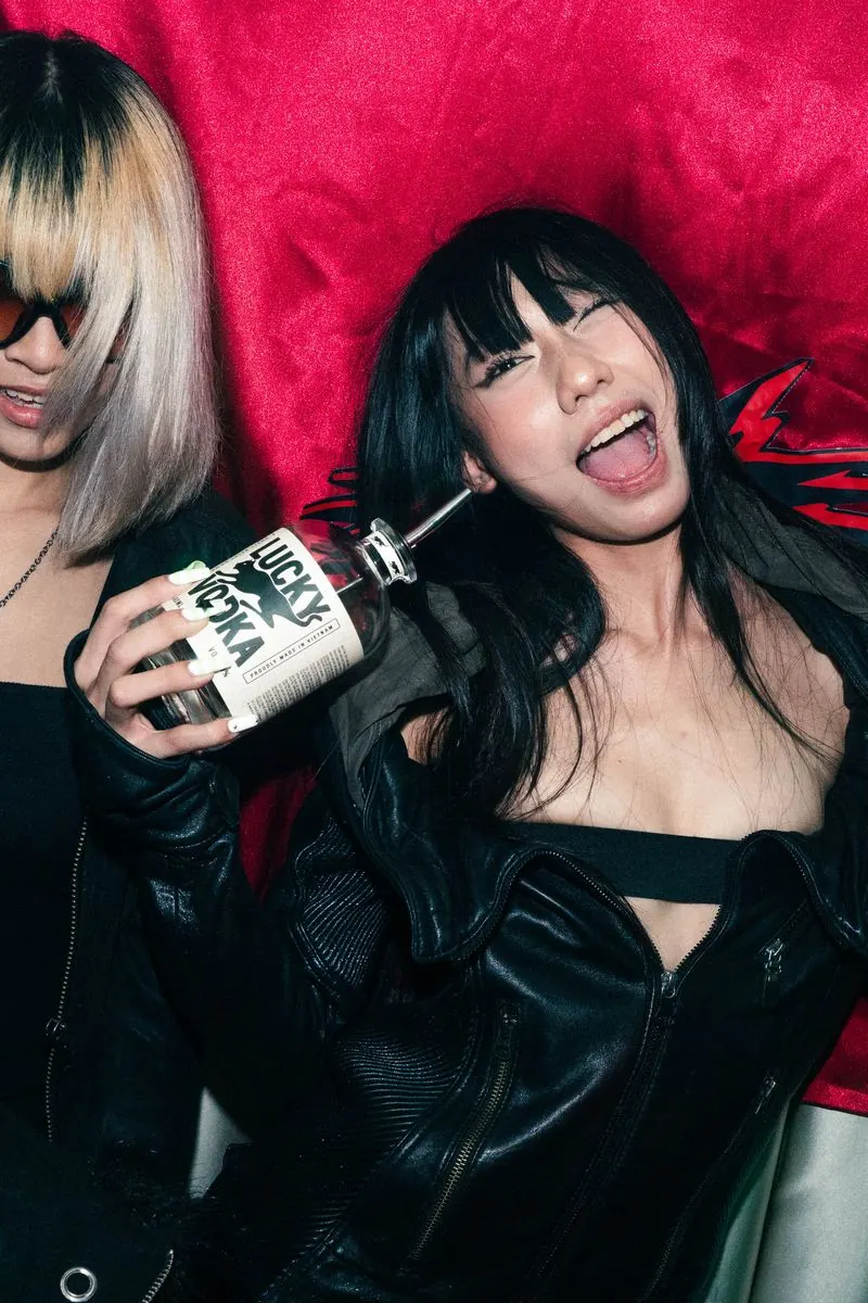 Two girls partying with a bottle of Lucky Vodka